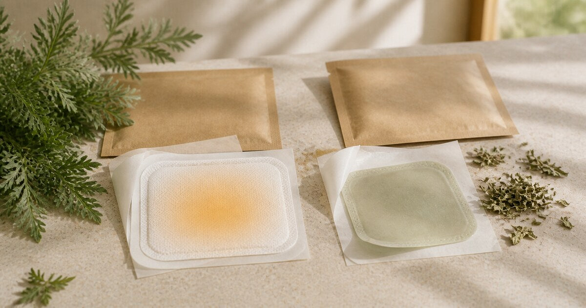Two fabric pouches and square reusable warming packs in amber and pale green on cream linen