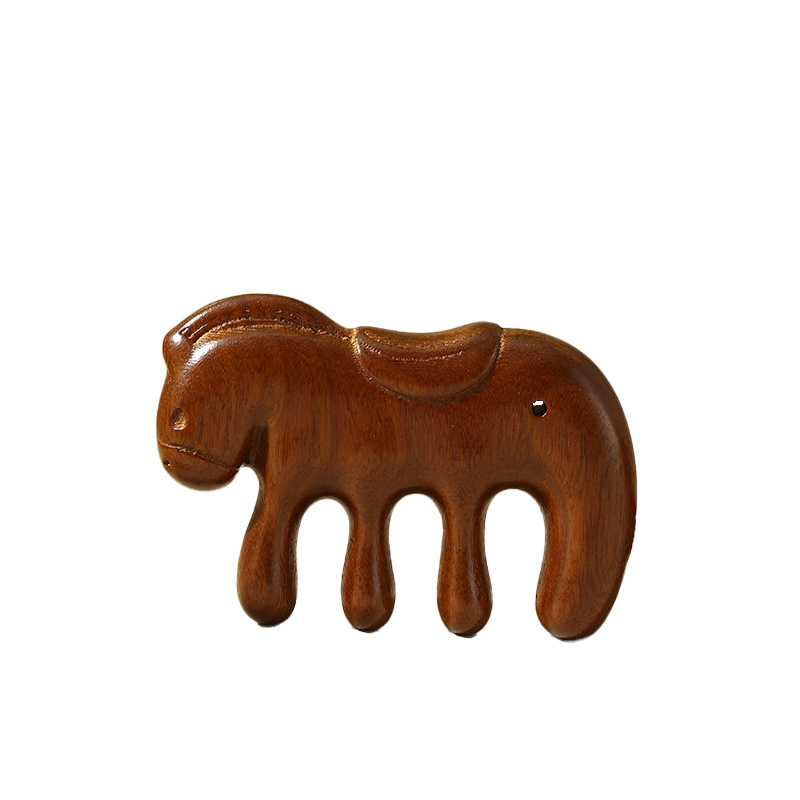 Side view of the carved sandalwood horse comb on a white background, showing its four rounded teeth.