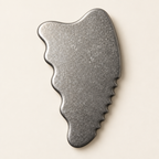 Macro view of the smooth shaped edges and crystalline grain of the titanium gua sha