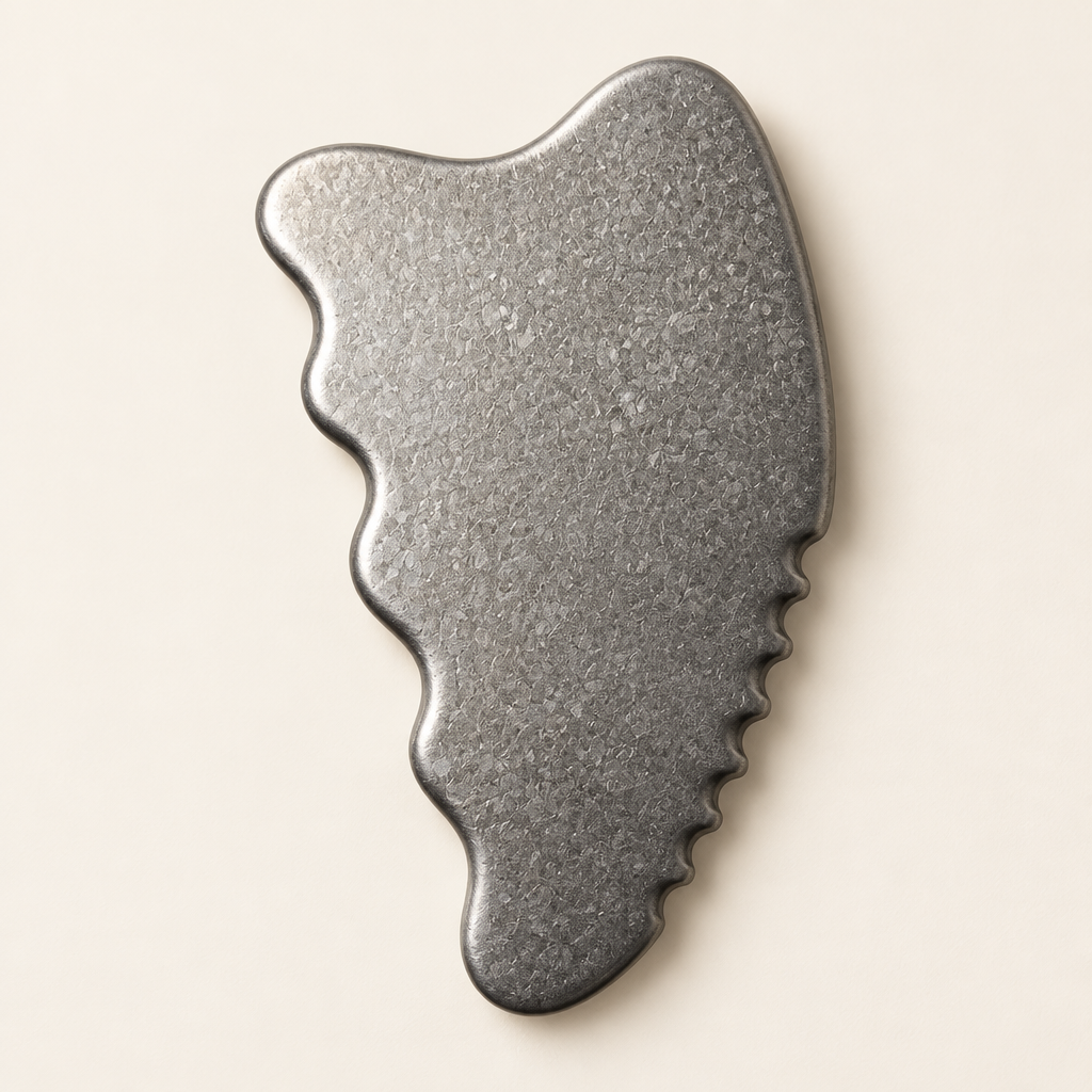 Macro view of the smooth shaped edges and crystalline grain of the titanium gua sha