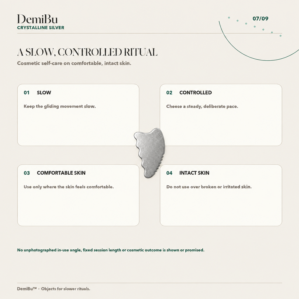 Light silver-gray titanium gua sha shown in a slow controlled self-care routine