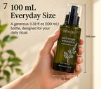 Hand holding a 100 mL DemiBu Mugwort Hydrosol bottle with size markings