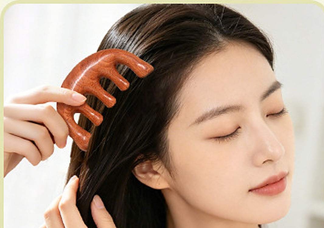 Woman using a wooden five-tooth comb across her scalp before bed