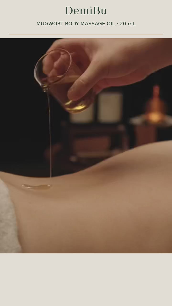 Applying mugwort massage oil to the calf during evening ritual